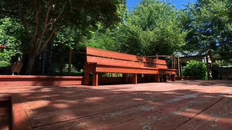 Backyard bench in the garden on a beautiful summer day. Stock Footage 93294223