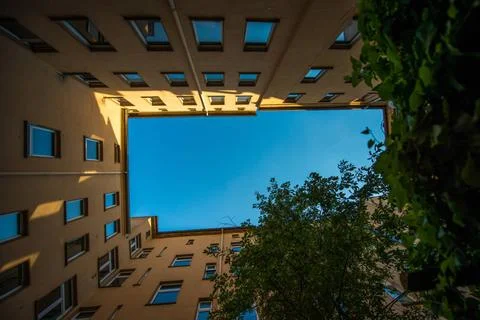 Backyard in Berlin rectangular backyard surrounded by yellow walls viewed ... Stock Photos