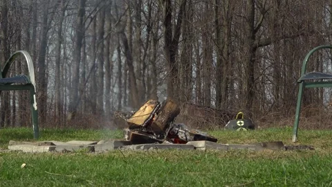 Backyard Campfire Pit Between Lawn Chairs with Forest Background Stock Footage 345004991