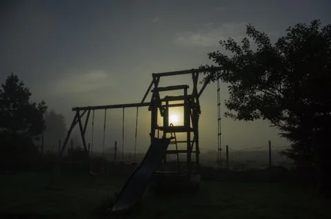 The backyard at dawn over a dark gradient purple sky. Southern Norway Stockfoto's
