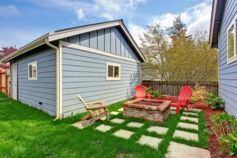 Backyard with fire pit and deck chairs Stock Photos
