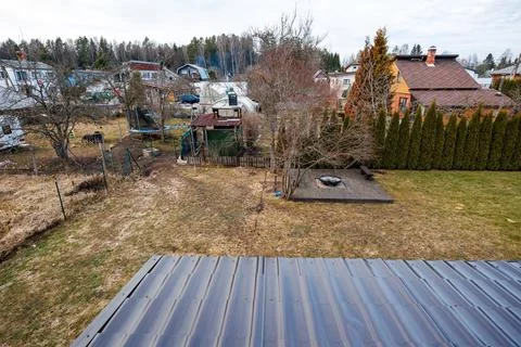 Backyard fire pit, arborvitae hedges, and village yards in suburb Stock Photos