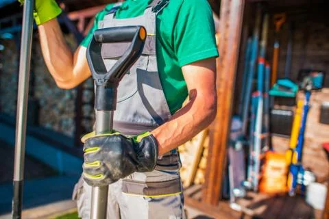 Backyard Garden Work Time. Men with Garden Tools. Stock Photos