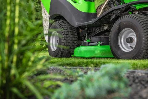 Backyard Grass Mowing Using Riding Garden Tractor Stock Photos