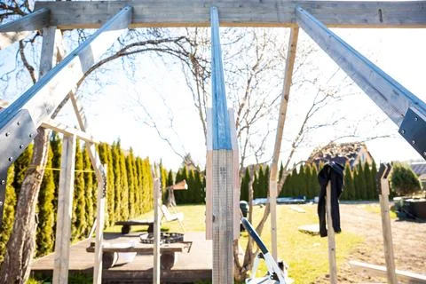 Backyard greenhouse framing with timber studs and metal rafters Stock Photos