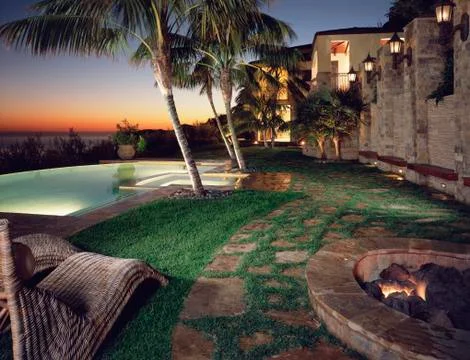 Backyard of modern home with pool at sunset Stock Photos