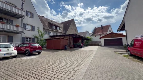 A backyard is nicely paved and has been converted into a parking lot Stock-Footage 338011782