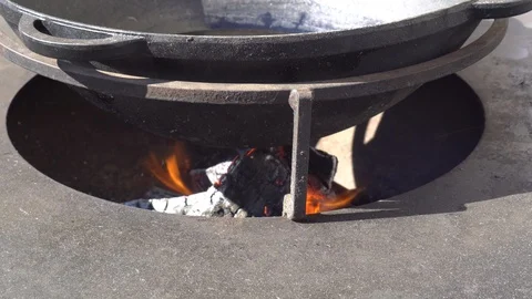 Backyard Open Fire Cooking. Large cast iron cauldron on the fire Stock Footage 126808047