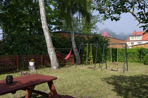 Backyard with Picnic Table, Hammock, and Swings Stock Photos