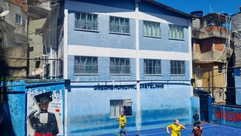 Backyard scene in Rocinha favela, Rio de Janeiro, Brazil, where children and Видео 335347255
