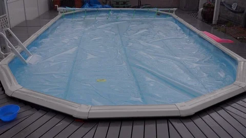 Backyard Simming Pool During Rain Storm with Cover on Video stock 114342247