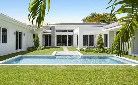 Backyard Surrounded by large vegetation short grass, stone paths Stock Photos
