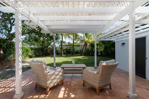 Backyard Surrounded by large vegetation short grass, stone paths Stock Photos