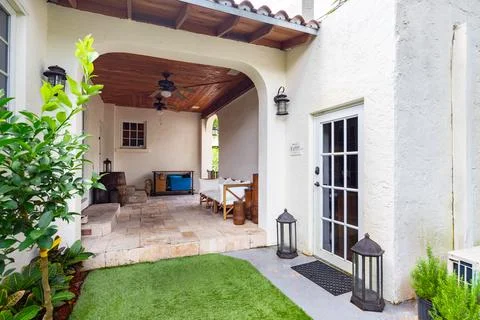 Backyard Surrounded by large vegetation short grass, stone paths Stock Photos