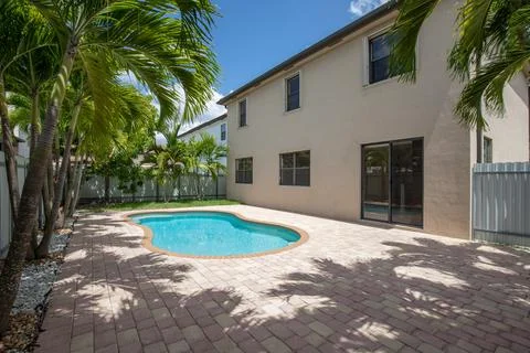 Backyard Surrounded by large vegetation short grass, stone paths Stock Photos