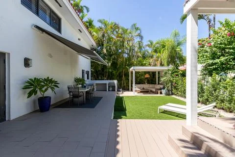 Backyard Surrounded by large vegetation short grass, stone paths Stock Photos
