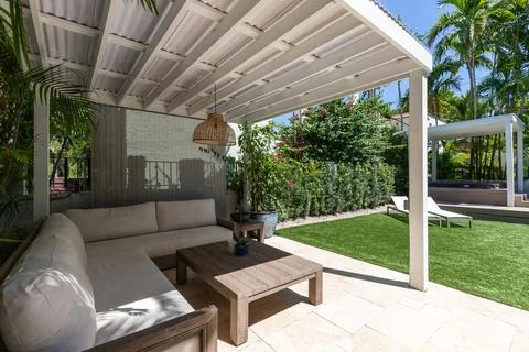 Backyard Surrounded by large vegetation short grass, stone paths Stock Photos