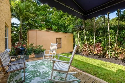 Backyard Surrounded by large vegetation short grass, stone paths. Stock Photos