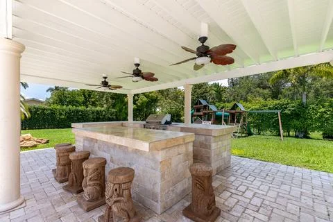 Backyard Surrounded by large vegetation short grass, stone paths Stock Photos