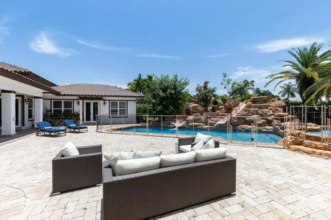 Backyard Surrounded by large vegetation short grass, stone paths Stock Photos