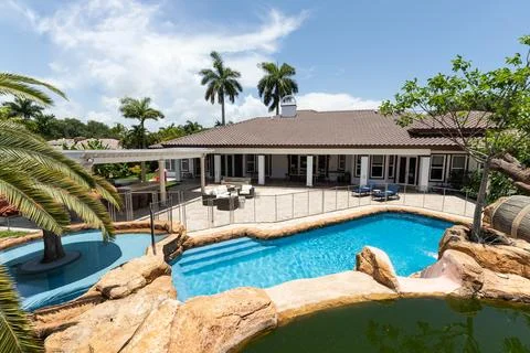 Backyard Surrounded by large vegetation short grass, stone paths Stock Photos