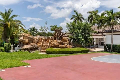 Backyard Surrounded by large vegetation short grass, stone paths Stock Photos