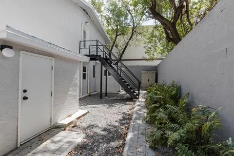 Backyard Surrounded by large vegetation short grass, stone paths Stock Photos