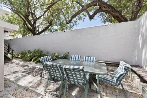 Backyard Surrounded by large vegetation short grass, stone paths Stock Photos