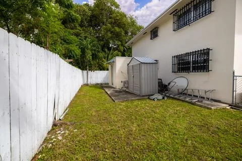 Backyard Surrounded by large vegetation short grass, stone paths Stock Photos