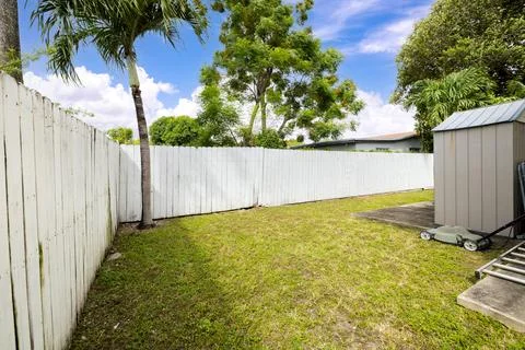 Backyard Surrounded by large vegetation short grass, stone paths. Stock Photos