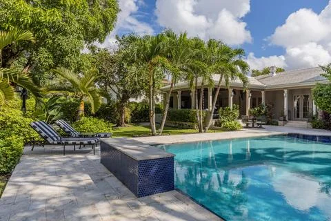 Backyard Surrounded by large vegetation short grass, stone paths Stock Photos
