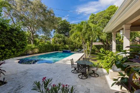Backyard Surrounded by large vegetation short grass, stone paths Stock Photos