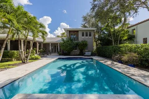 Backyard Surrounded by large vegetation short grass, stone paths Stock Photos