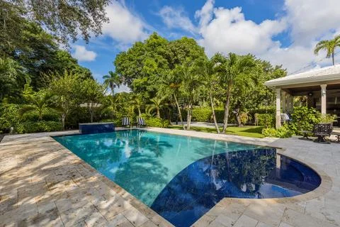 Backyard Surrounded by large vegetation short grass, stone paths Stock Photos