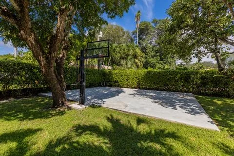 Backyard Surrounded by large vegetation short grass, stone paths Stock Photos