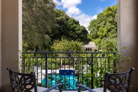 Backyard Surrounded by large vegetation short grass, stone paths Stock Photos