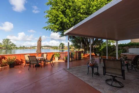 Backyard Surrounded by large vegetation tile floor and pool. Stock Photos