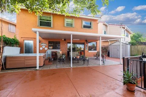 Backyard Surrounded by large vegetation tile floor and pool. Stock Photos