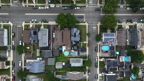 Backyard swimming pools cluster between dense rowhouses in Belleville New Stock Footage 340924899