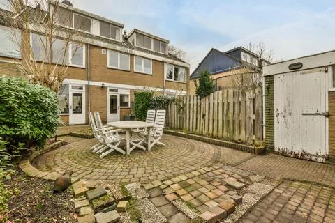 A backyard with a tile pattern on the path Stock Photos