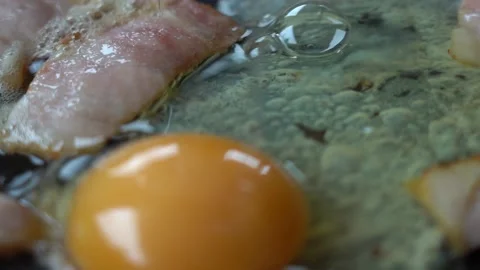 BACON and EGG are COOKED in a frying pan.  Stock Footage 140082098