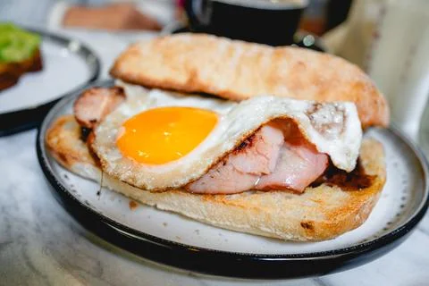 Bacon and Egg Roll Served on a Plate in a Caf Stock Photos