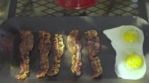 Bacon and Eggs Cooking Over A Campfire Stock Footage 61215442