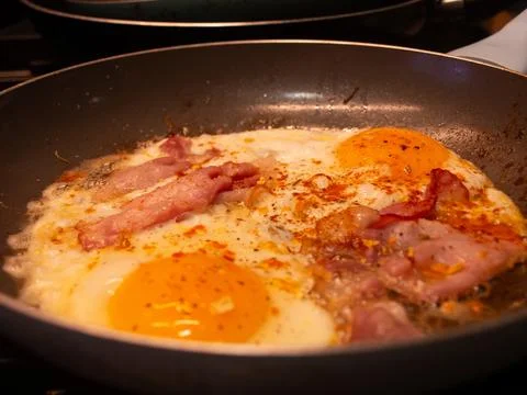 Bacon and eggs in pan Stock Photos