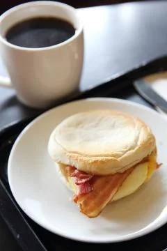 Bacon and fried egg roll with coffee Stock Photos