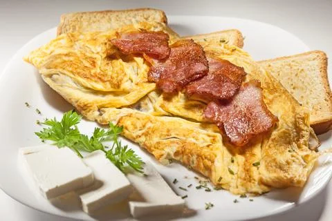 Bacon and scrambled eggs Stock Photos