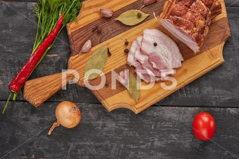 Bacon and seasonings on a wooden table Stock Photos