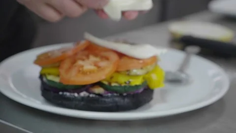  Bacon burger with beef patty on red wooden table Stock Footage 104103251