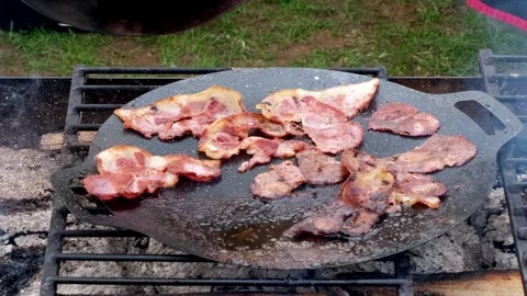 Bacon cooking on a BBQ Video stock 315372910