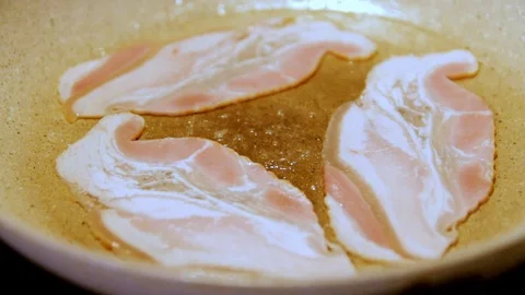 Bacon cooking on a hot white pan Stock Footage 100684523